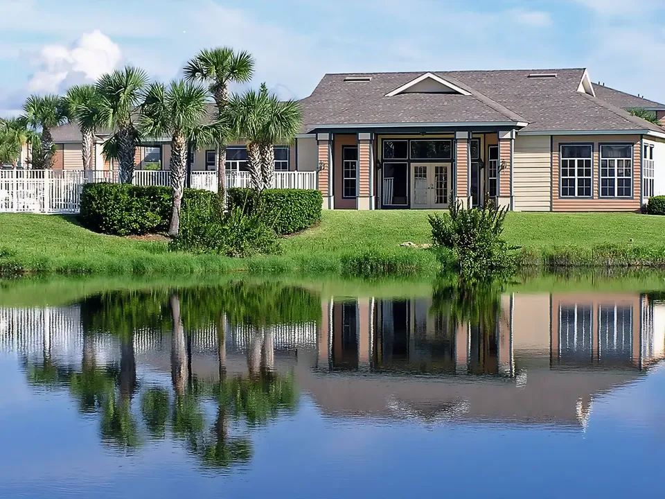 The palm-lined clubhouse reflected in the lake at Indian River in Vero Beach, Florida.