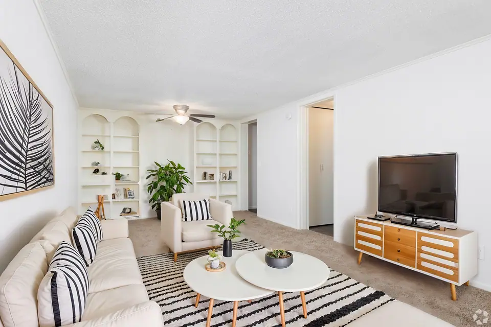 A bright furnished apartment living room at Palm Harbor Villas in Melbourne, Florida.