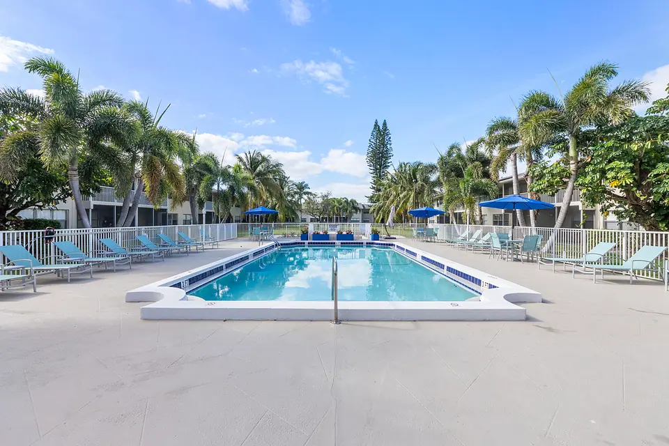The community pool and palm-lined deck at Waterford Bay in Boca Raton, Florida.